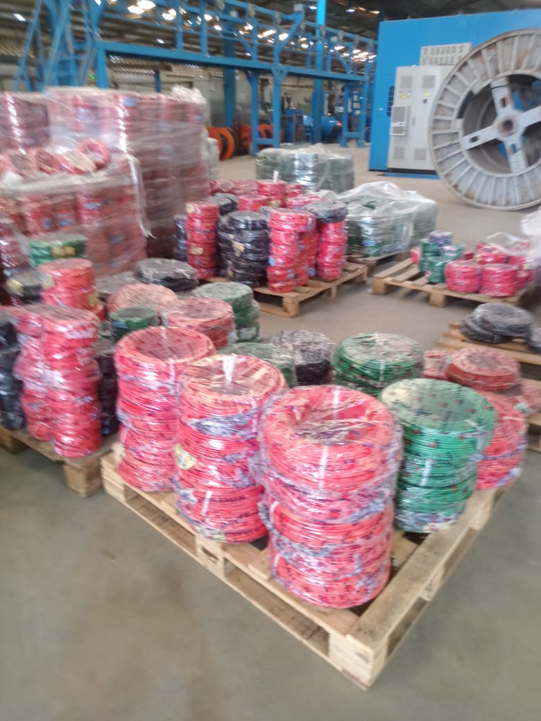 Pallets of wiring cable coils on the warehouse floor