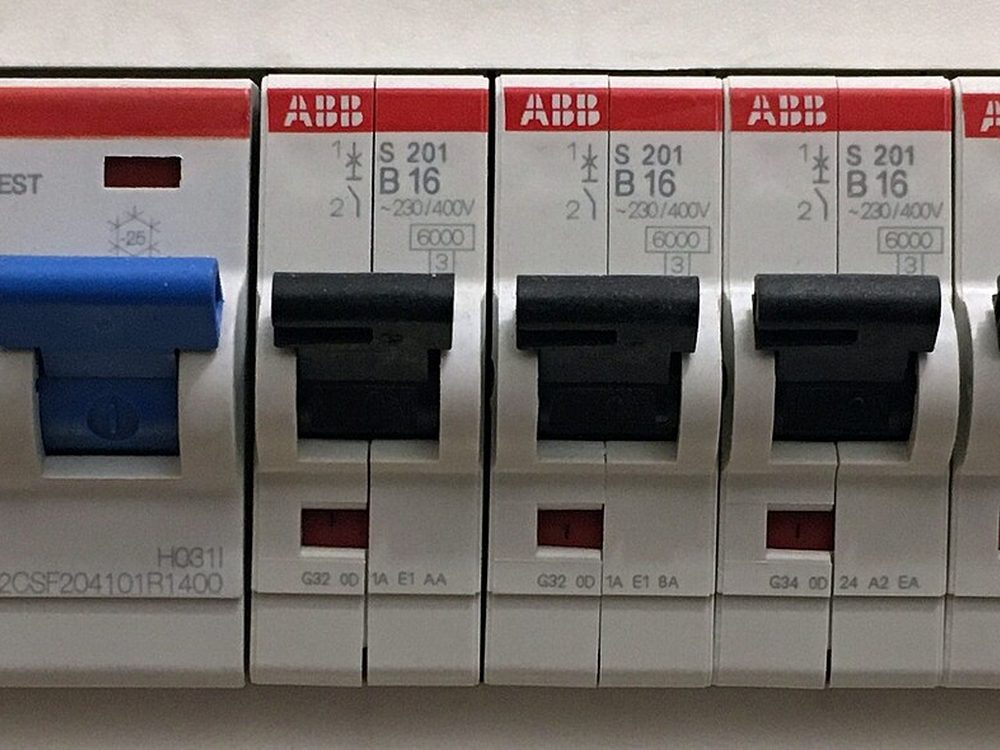 Row of miniature circuit breakers on a DIN rail